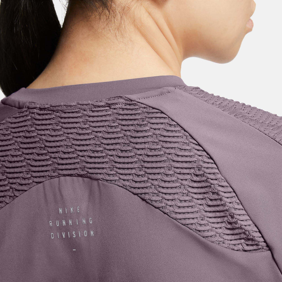 Upper back view of Nike Women's Dri-Fit ADV Run DVN SS Top in purple (7683344826530)