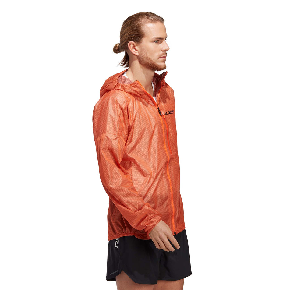Side view of a model wearing an adidas Men's Terrex Agravic 2.5L Rain.RDY Jacket (7766903292066)
