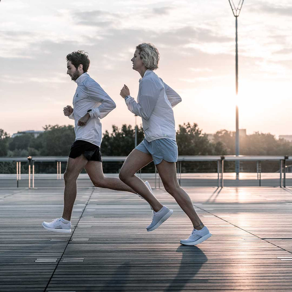 Man and woman running outdoors wearing Salomon Unisex INDEX.01 running shoes (6888669937826)