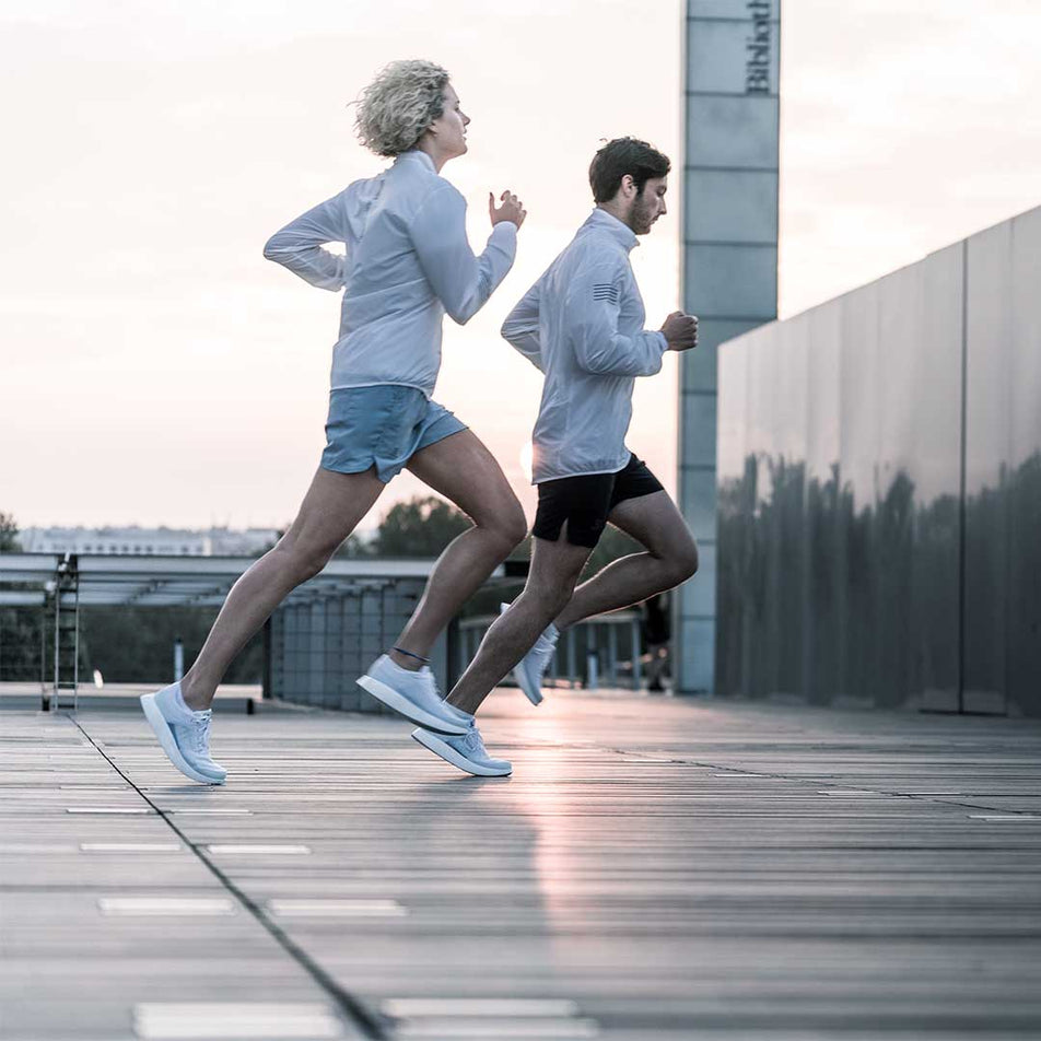 Man and woman running outdoors wearing Salomon Unisex INDEX.01 running shoes (6888669937826)