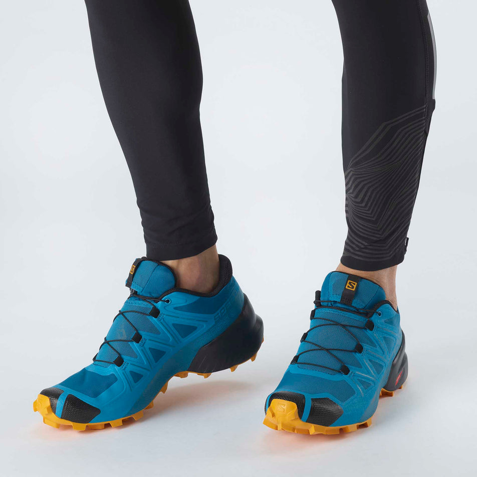 Man wearing a pair of Salomon Speedcross 5 running shoes (6888628093090)
