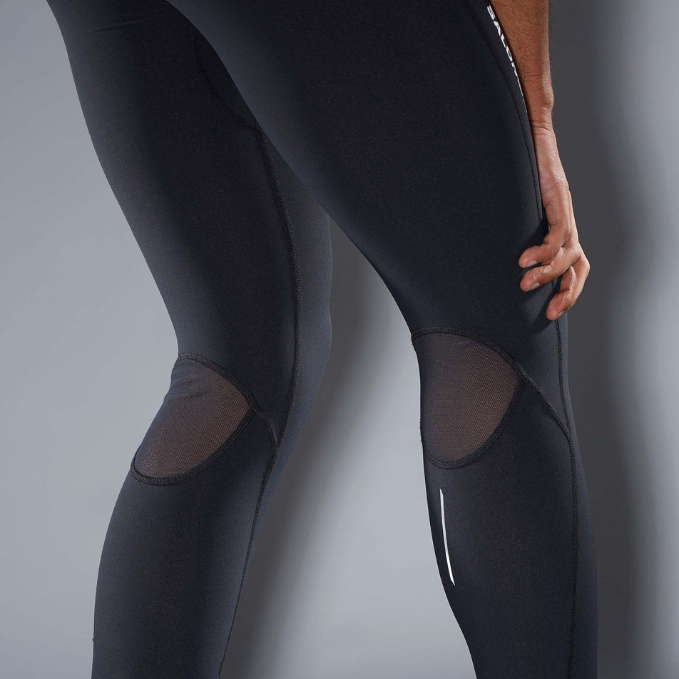 Close-up view of the back of a thigh and calf sections on a pair of Salomon Men's Sense Aero Tights in the Deep Black colourway. Lighter mesh is directly behind the knee. (7565961625762)