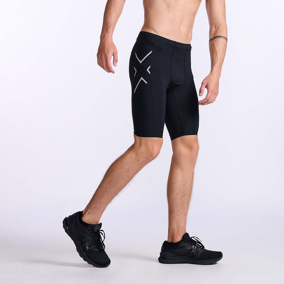 Lateral right side and front view of a pair of 2XU Men's Aero Compression Shorts, being worn by a model (7778319859874)