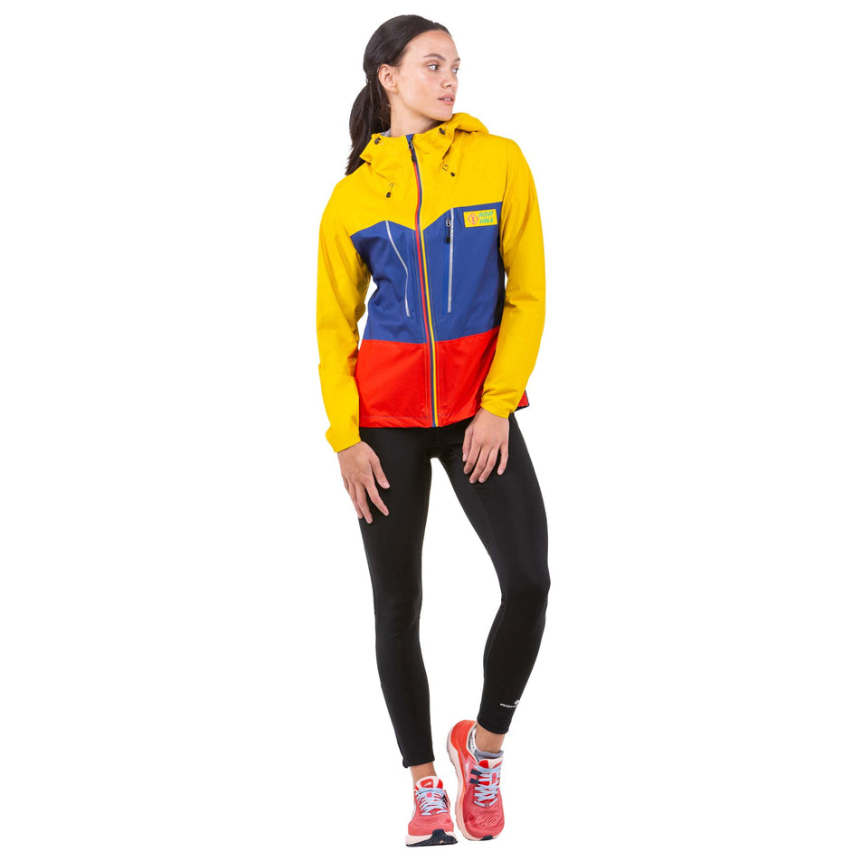 Front view of a model wearing a Ronhill Women's Tech Fortify Jacket in the Dark Cobalt/Solar colourway (7746201976994)