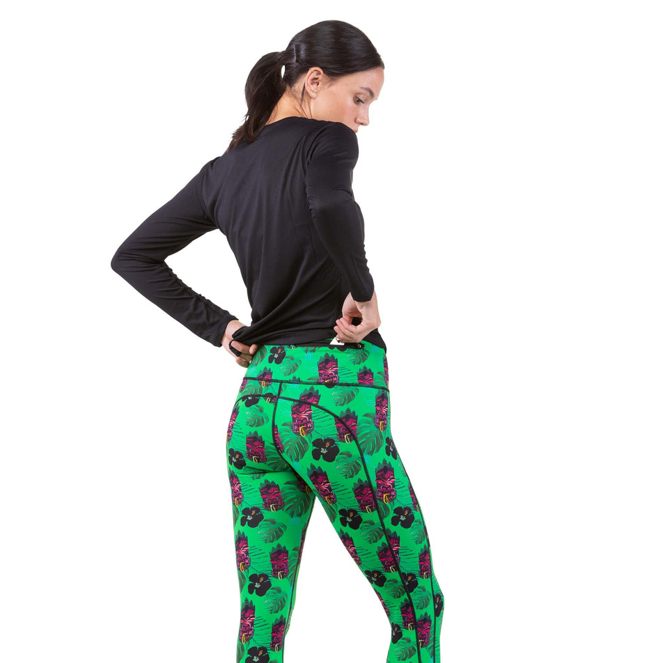 A model taking taking something out of the zipped back pocket on a pair of Ronhill Women's Life Crop Tights (7746135589026)