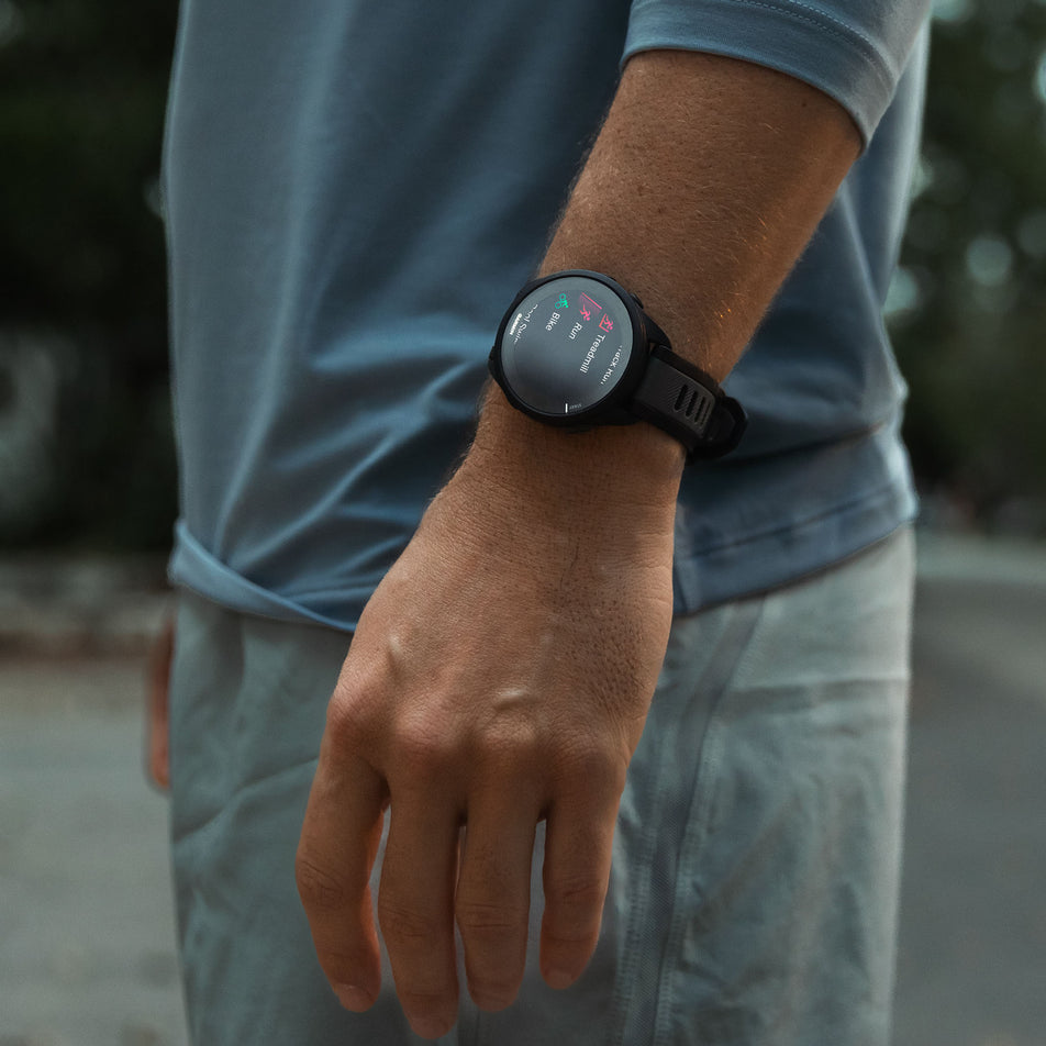 A model wearing a Garmin Forerunner 165 Running Smartwatch in the Black/Slate Grey colourway (8186711736482)