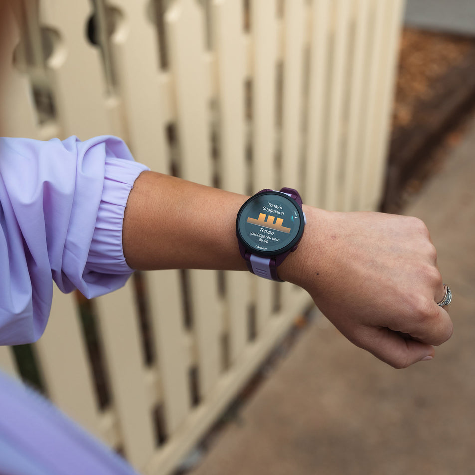 A model wearing a Garmin Forerunner 165 Music Running Smartwatch in the Black/Slate Grey colourway (8186716520610)
