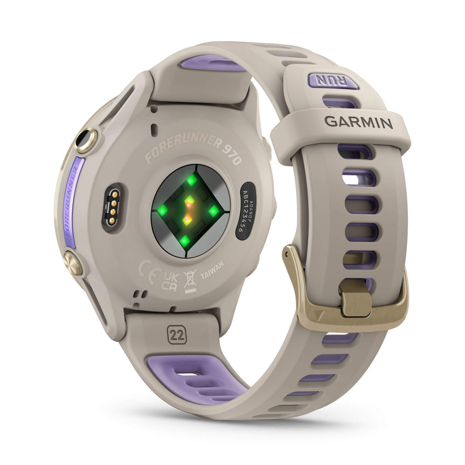 A Garmin Forerunner 970. Soft Gold Titanium with French Grey Case and French Grey/Translucent Indigo Band. Back of watch and wrist-based heart rate monitor. (8692403962018)