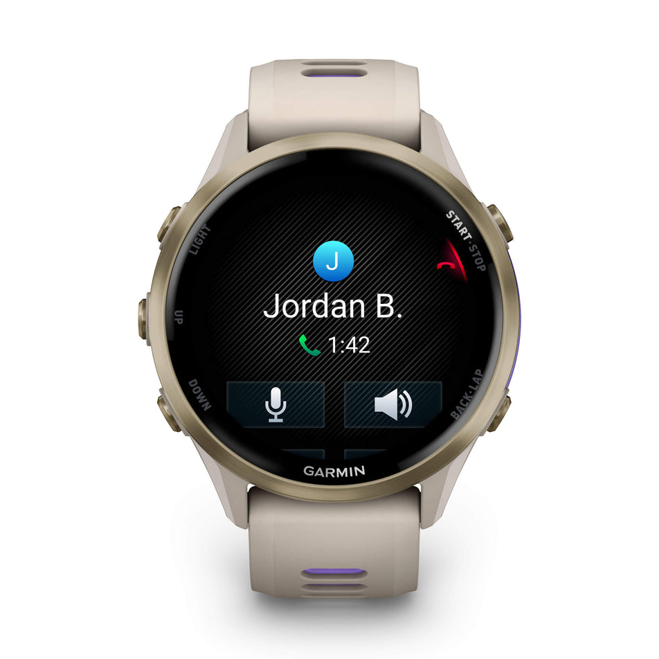 A Garmin Forerunner 970. Soft Gold Titanium with French Grey Case and French Grey/Translucent Indigo Band. Phone call screen. (8692403962018)