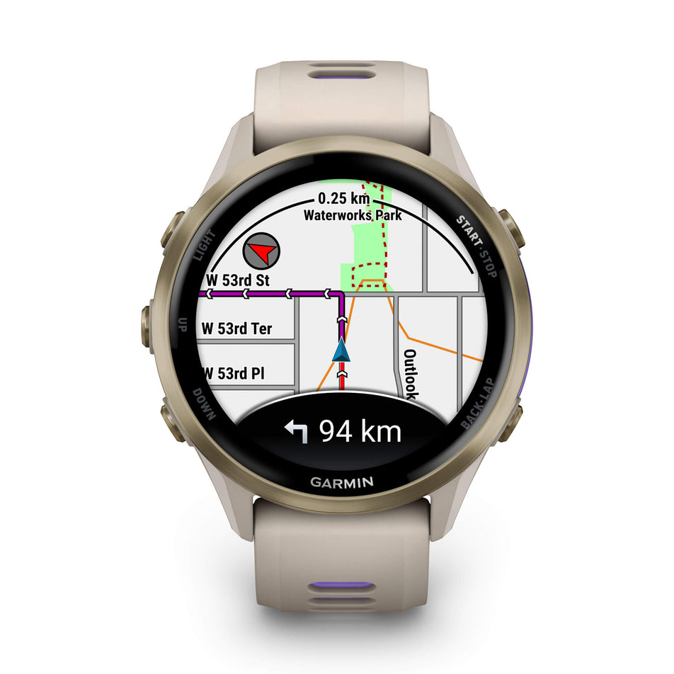 A Garmin Forerunner 970. Soft Gold Titanium with French Grey Case and French Grey/Translucent Indigo Band. Map screen. (8692403962018)