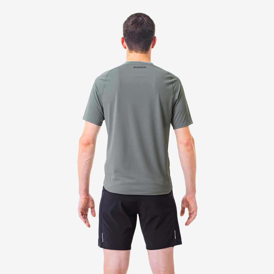 Back view of a model wearing a GOREWEAR Men's Everyday Solid Shirt in the Lab Gray colourway. Model is also wearing GOREWEAR shorts. (8166479855778)