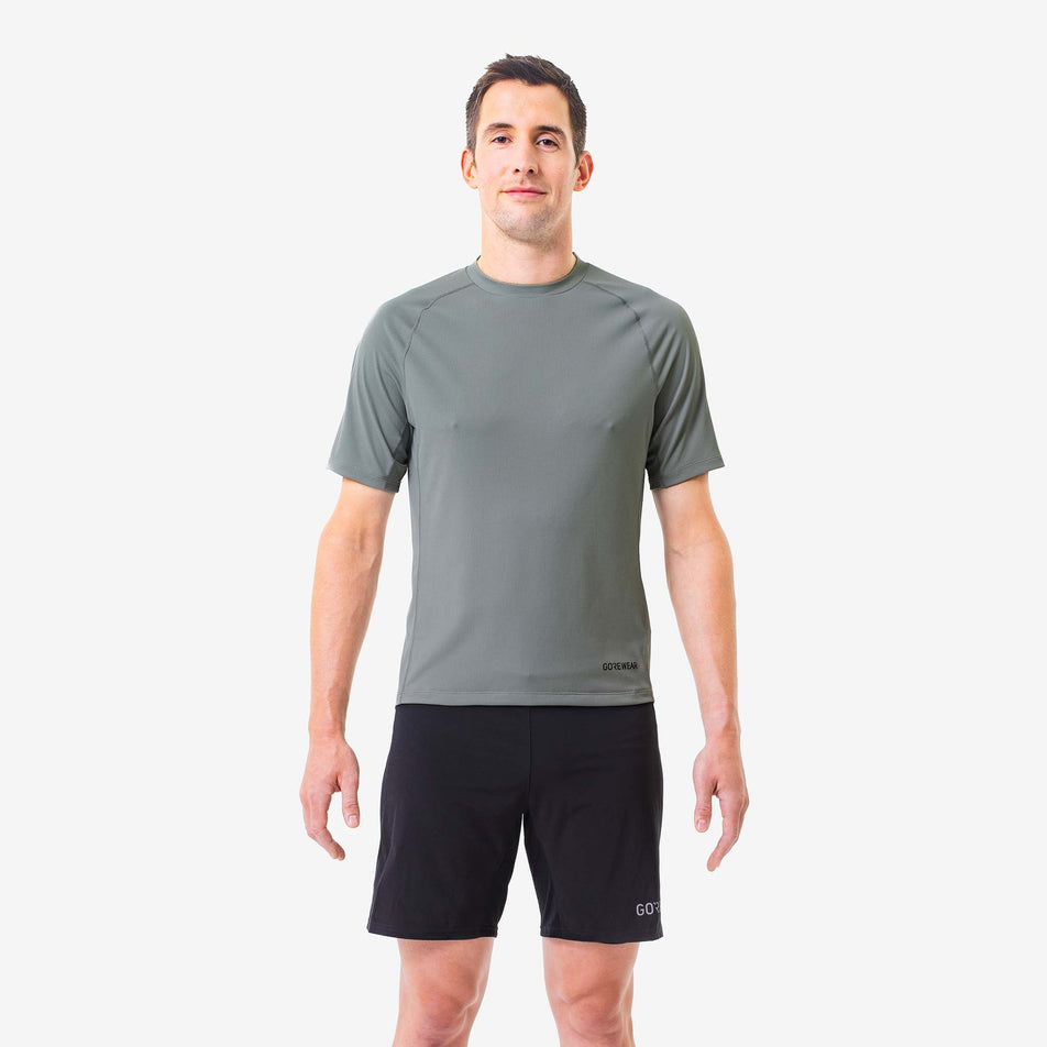 Front view of a model wearing a GOREWEAR Men's Everyday Solid Shirt in the Lab Gray colourway. Model is also wearing GOREWEAR shorts.  (8166479855778)