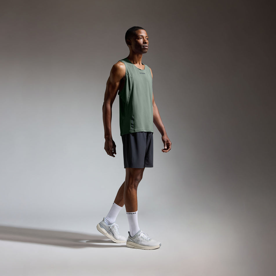 Angled view of a model wearing the GOREWEAR Men's Contest 2.0 Singlet in the Slate Green colourway.