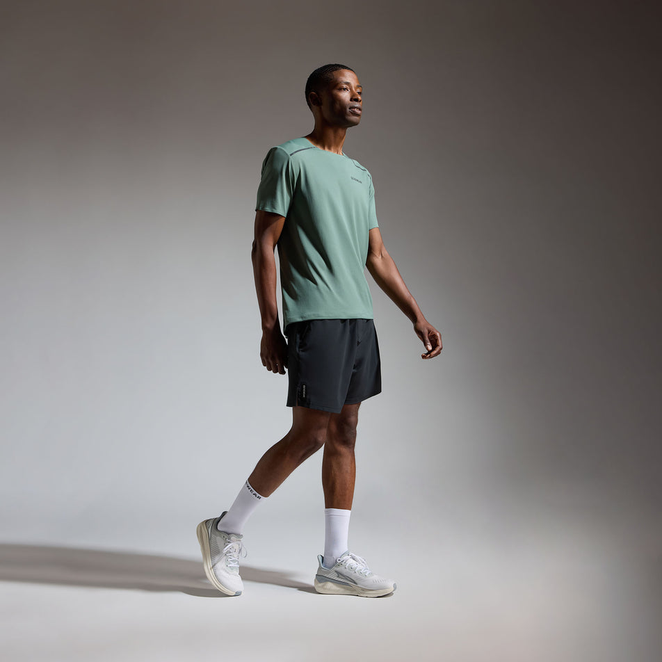 Angled view of a model wearing the GOREWEAR Men's Contest 2.0 Tee in the Slate Green colourway.