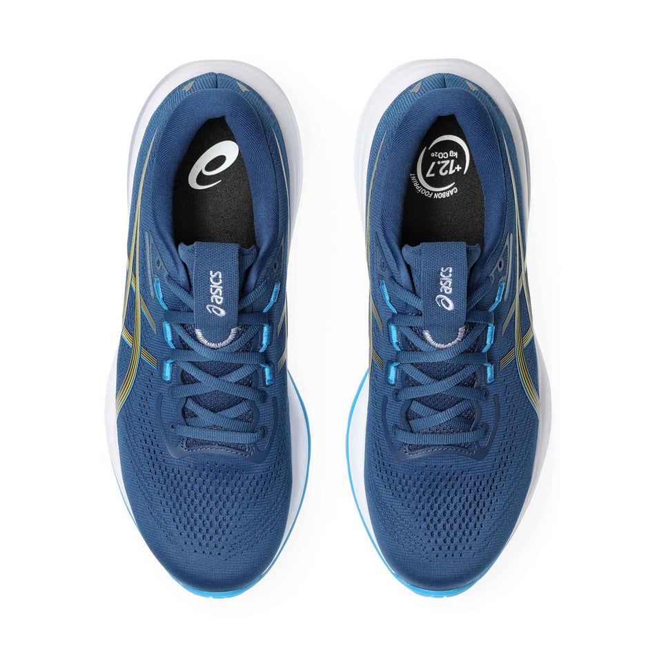 The uppers of a pair of ASICS Men's Gel-Cumulus 28 Running Shoes in the Twilight Blue/Amabuki colourway.
