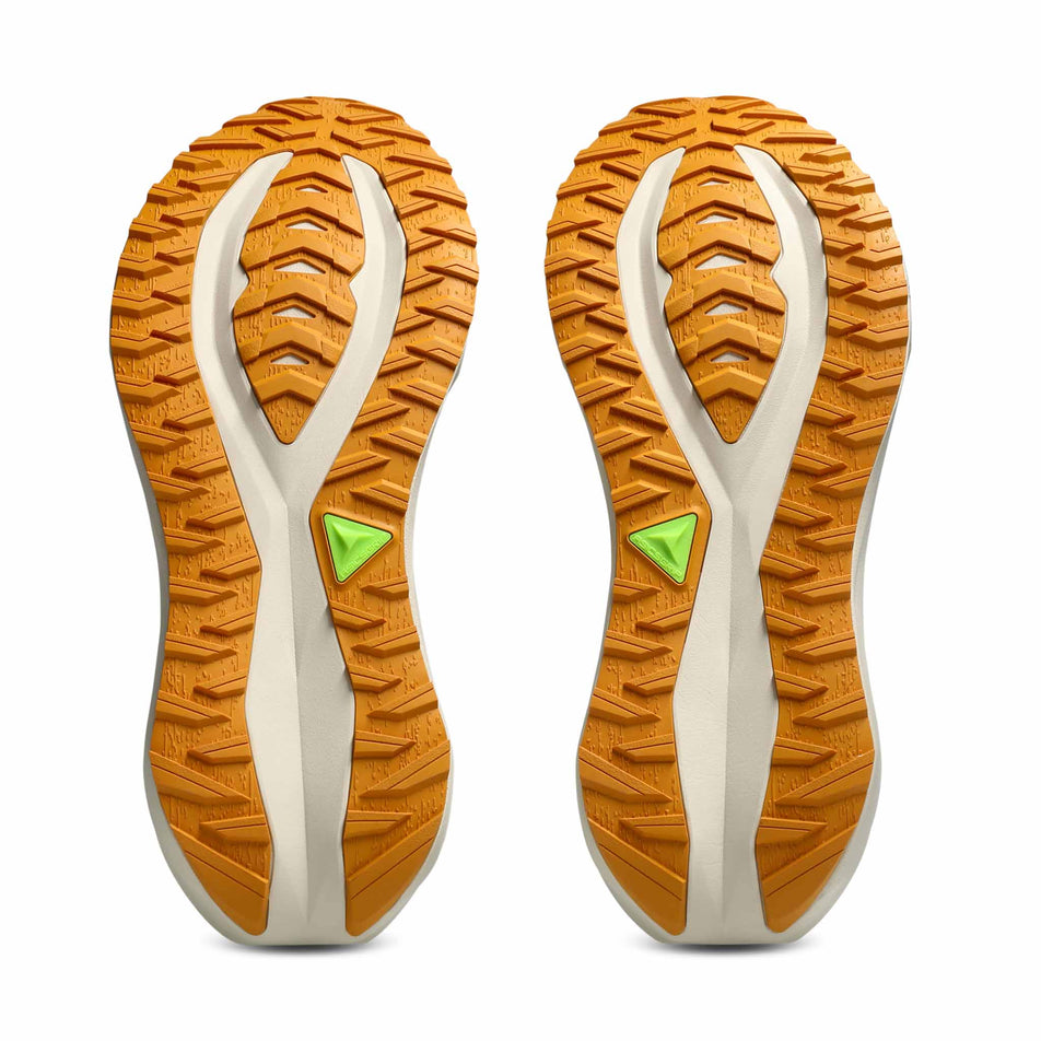 The outsoles of a pair of ASICS Men's Blazeblast Running Shoes in the Black/Sandstorm colourway.