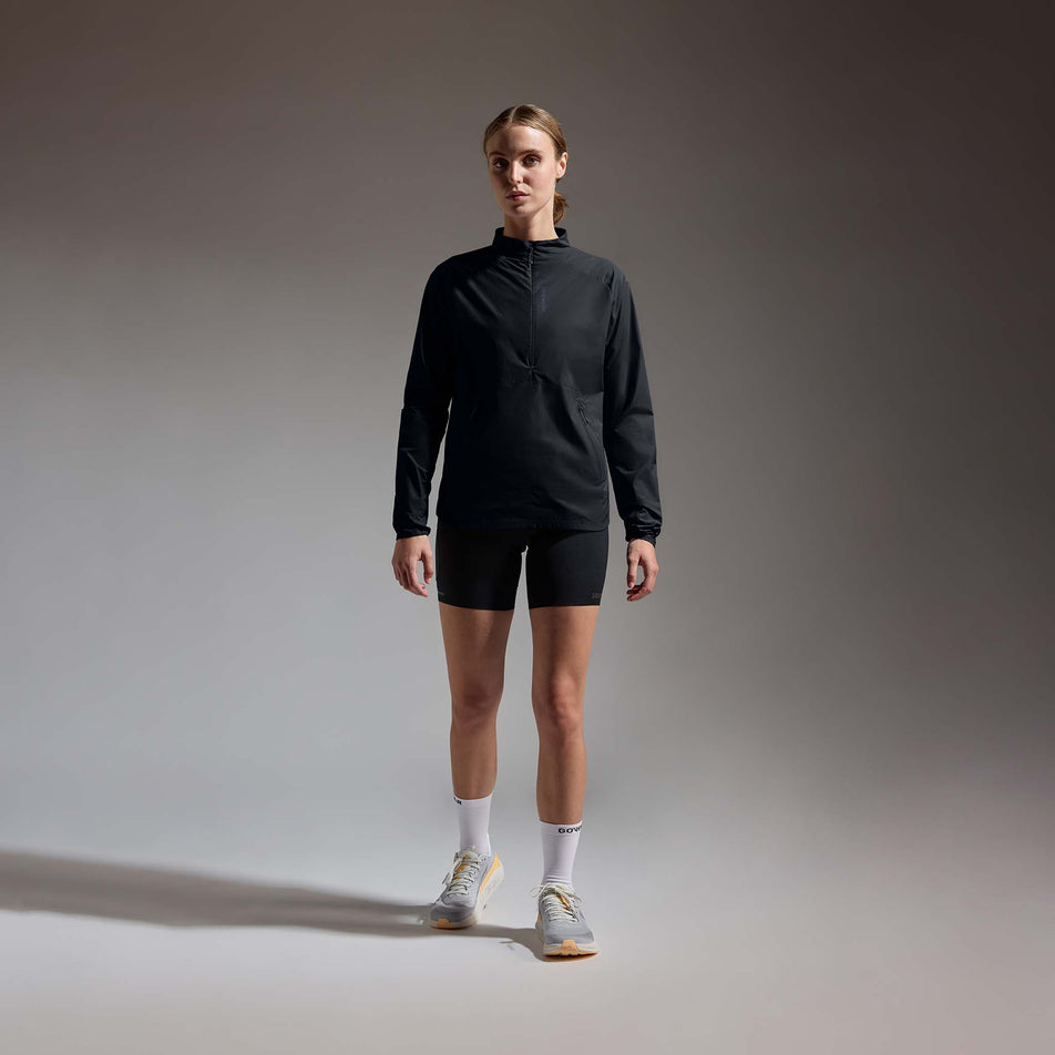 Front view of a model wearing the GOREWEAR Women's Concurve Windbreaker Anorak in the Black colourway.