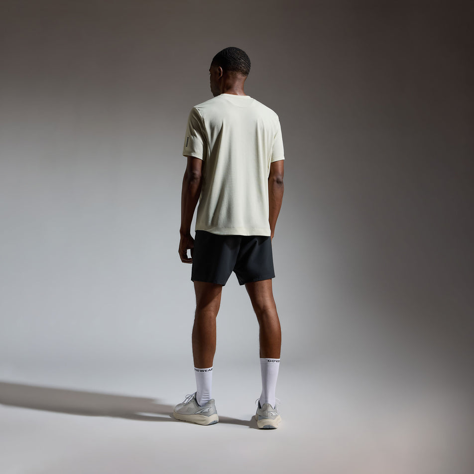 Back view of a model wearing the GOREWEAR Men's Training Tee in the Tech Beige colourway.