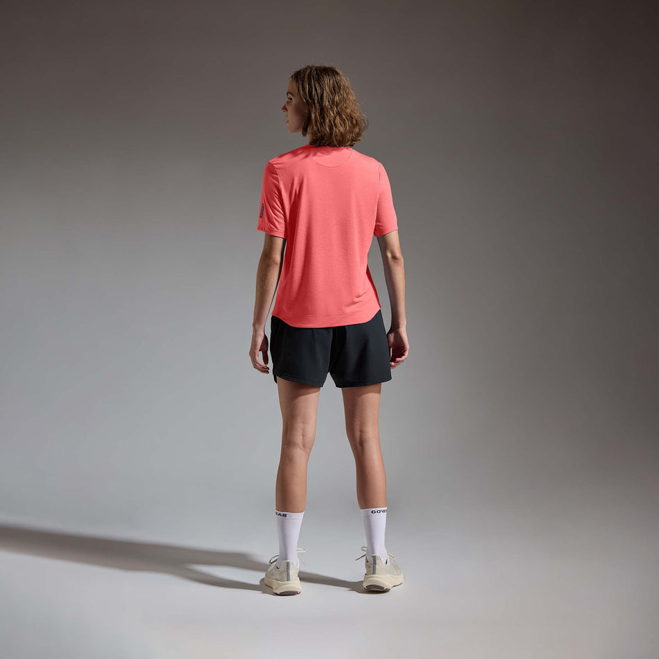 Back view of a model wearing the GOREWEAR Women's Training Tee in the Coral Red colourway.