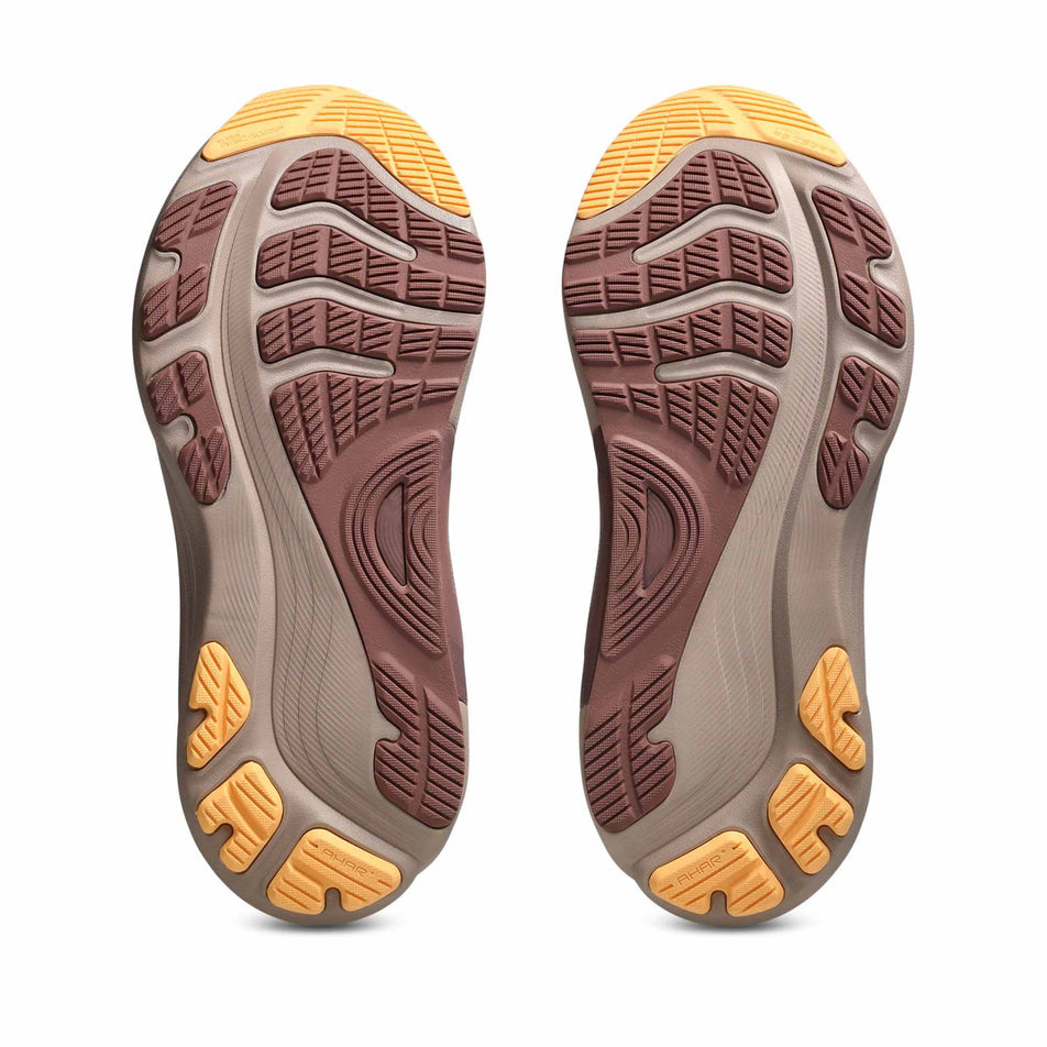 The outsoles of a pair of ASICS Women's Gel-Kayano 32 Running Shoes in the White/Orange Glow colourway. (8669086384290)