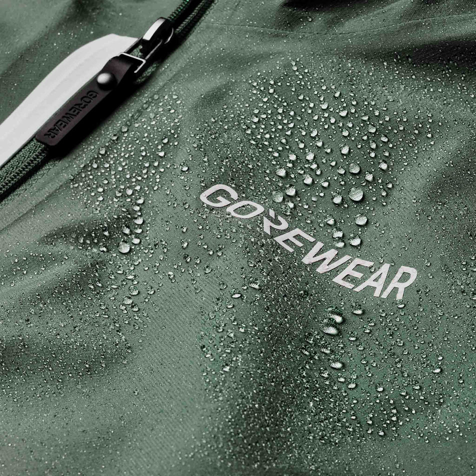 Water sitting on the fabric of the GOREWEAR Men's Concurve GORE-TEX Logo Jacket in the Slate Green colourway.
