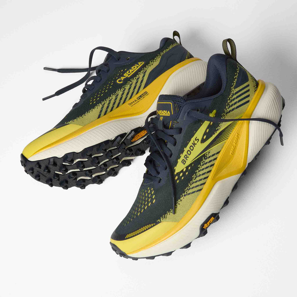 A pair of Brooks Men's Cascadia 20 Running Shoes in the Navy/Cyber Yellow/Grey colourway.