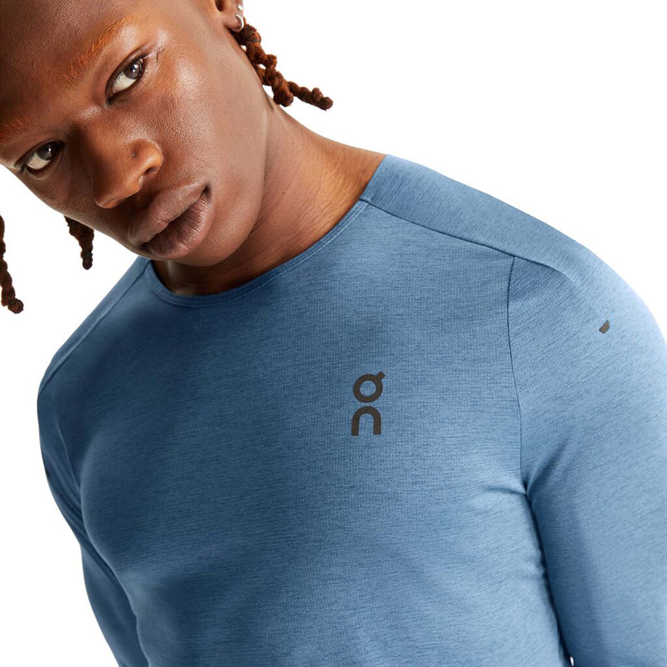 Close-up front view of a model wearing an On Men's Performance Long-T in the Stellar colourway. Upper third of the t-shirt is visible.  (8005042995362)