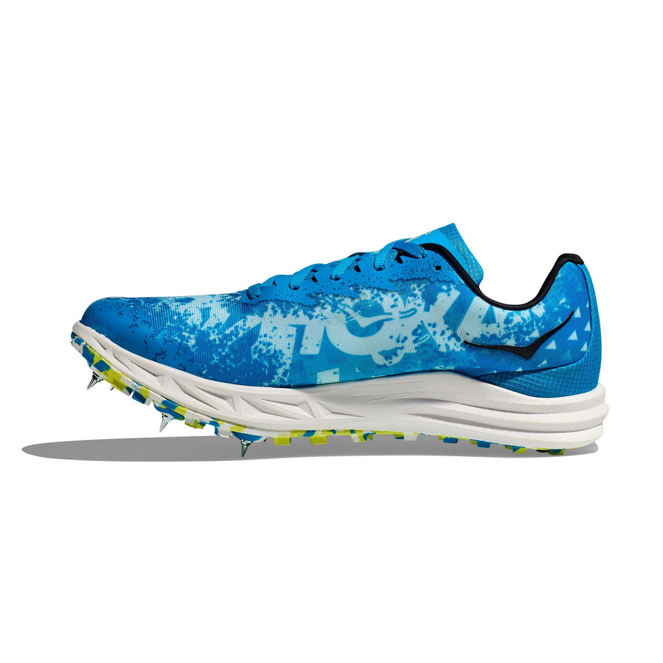 Medial side of the right shoe from a pair of Hoka Unisex Crescendo XC Spikes in the Diva Blue/Evening Primrose colourway (7922066096290)