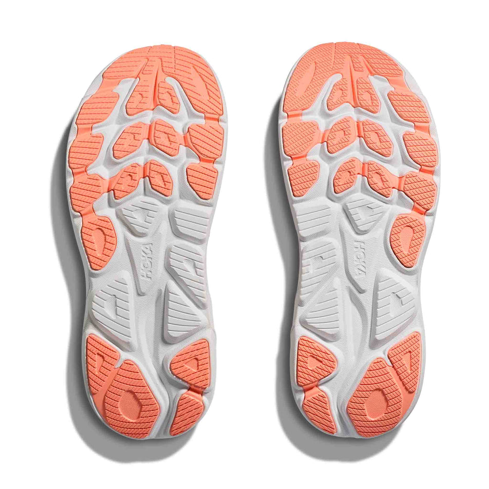 The outsoles of a pair of HOKA Women's Clifton 10 Running Shoes in the Lilac Cream/Tangerine Glow colourway.