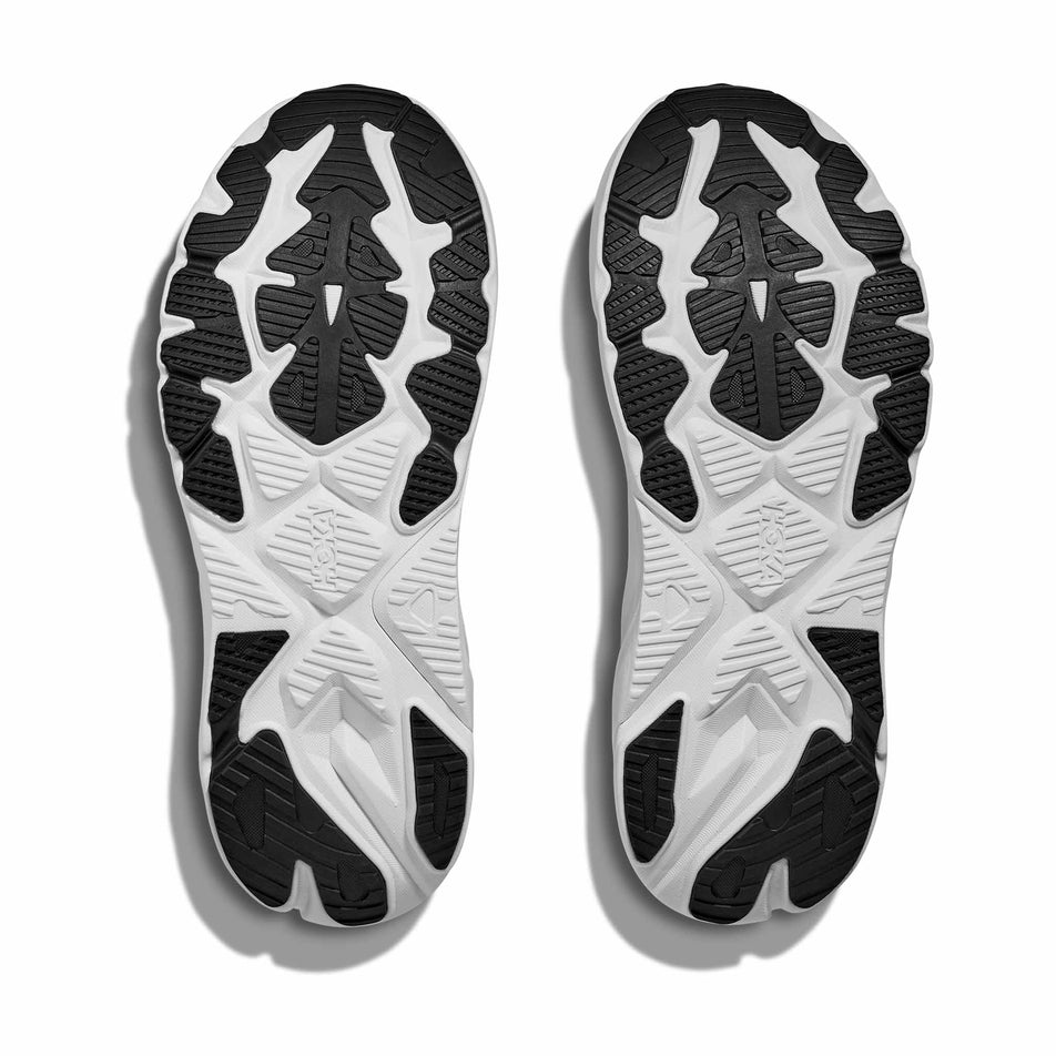 The outsoles of a pair of HOKA Women's Arahi 8 Running Shoes in the Black/White colourway.