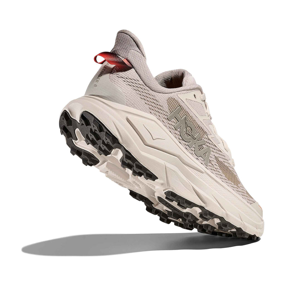 Lateral - and outsole - view of the right shoe from a pair of HOKA Women's Challenger 8 Running Shoes in the Stucco/Asphalt Grey colourway.