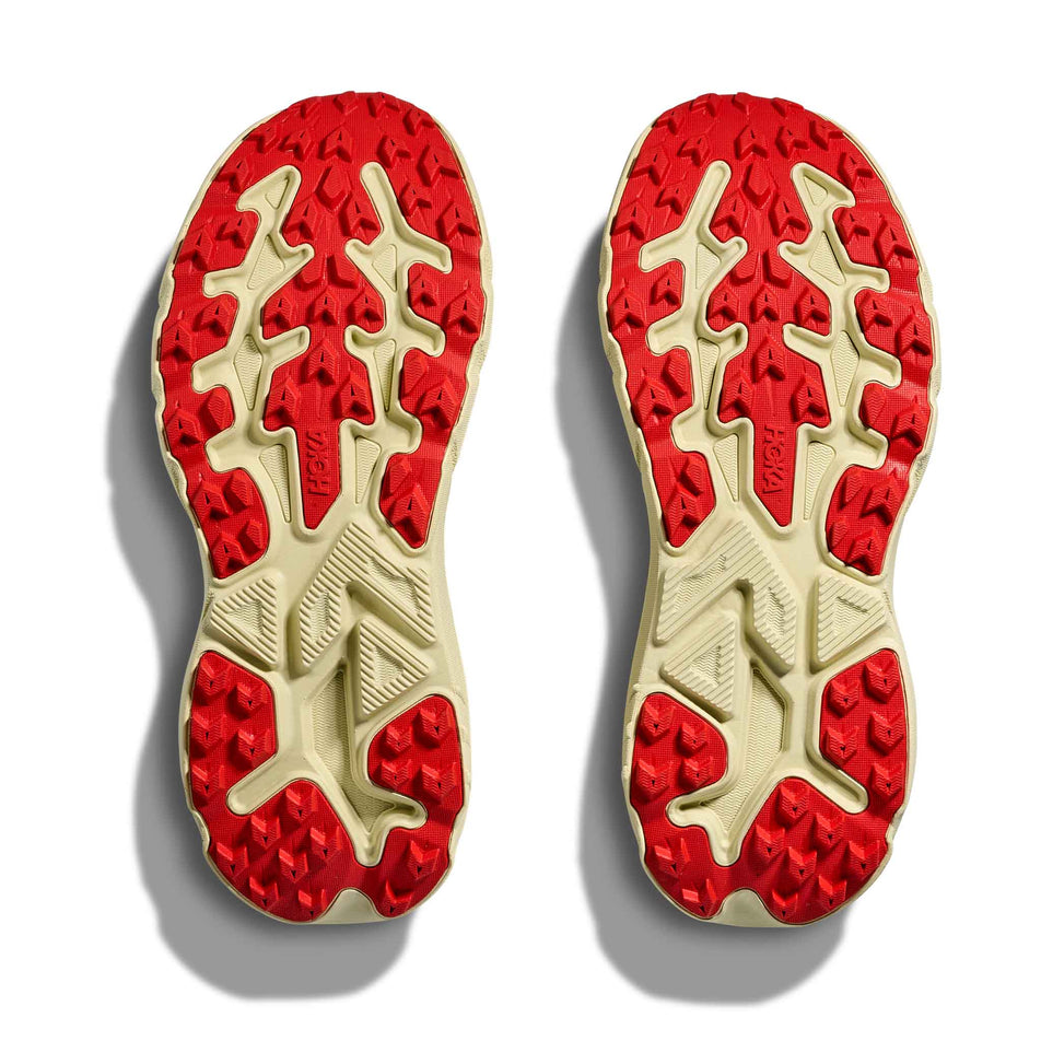 The outsoles of a pair of HOKA Women's Challenger 8 Running Shoes in the Tidal Wave/Pampas Grass colourway.