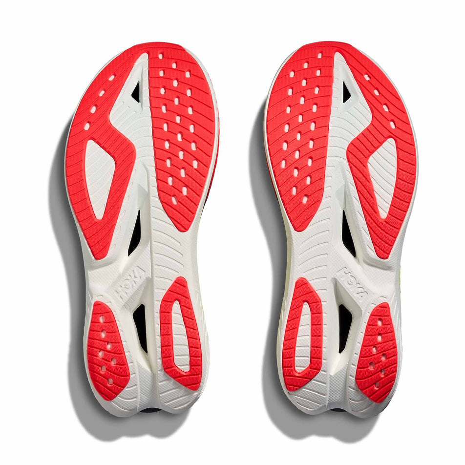 The outsoles of a pair of HOKA Women's Mach X 3 Running Shoes in the Neon Yuzu/Squid Ink colourway.