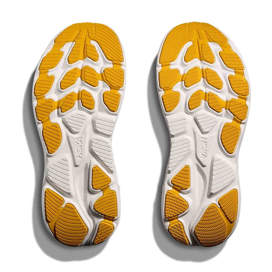 The outsoles of a pair of HOKA Clifton 10 Big Kids Running Shoes in the Alpine Blue/Foggy Night colourway.