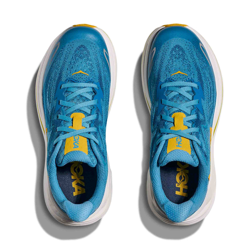 The uppers of a pair of HOKA Clifton 10 Big Kids Running Shoes in the Alpine Blue/Foggy Night colourway.