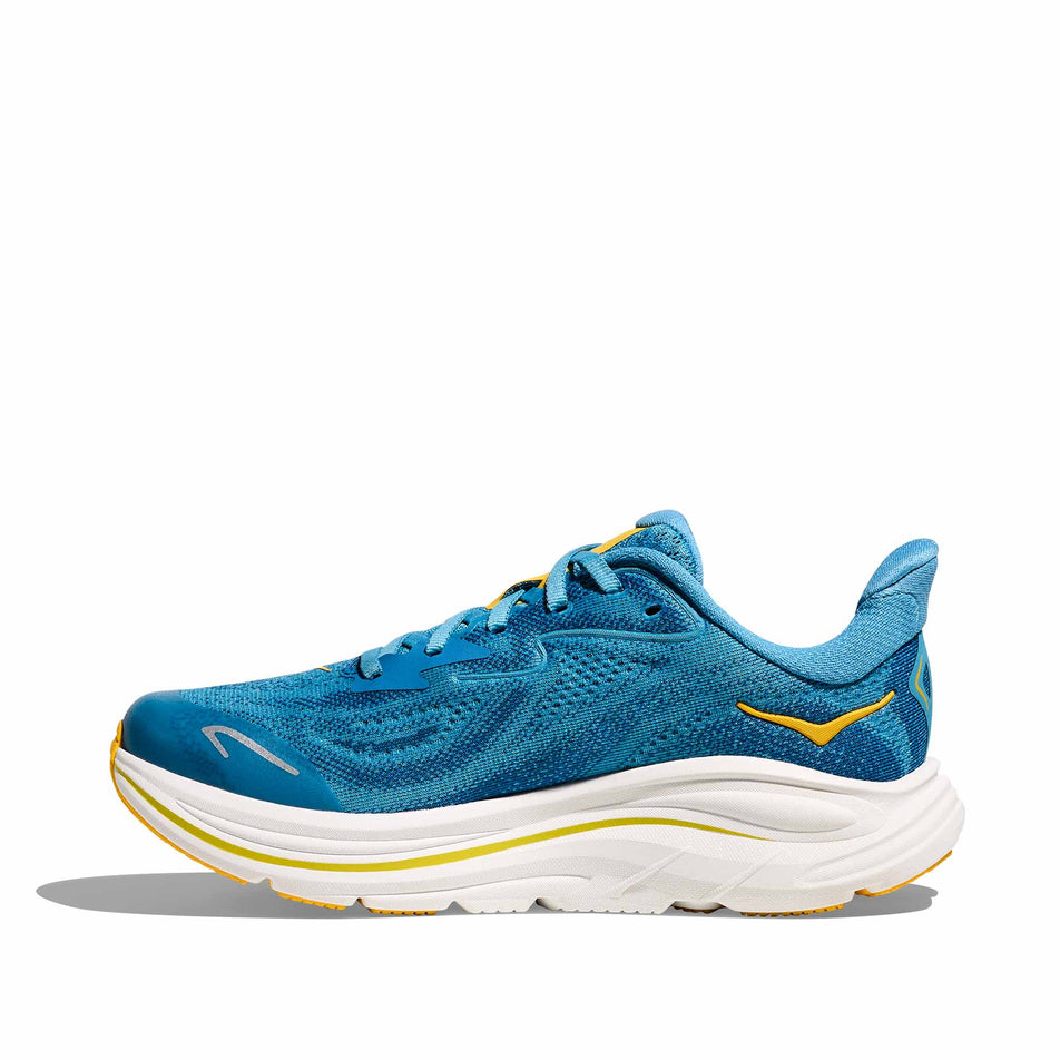 Medial view of the right shoe from a pair of HOKA Clifton 10 Big Kids Running Shoes in the Alpine Blue/Foggy Night colourway.