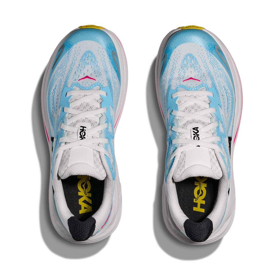 The uppers of a pair of HOKA Clifton 10 Big Kids Running Shoes in the Frost/Soaring Blue colourway.
