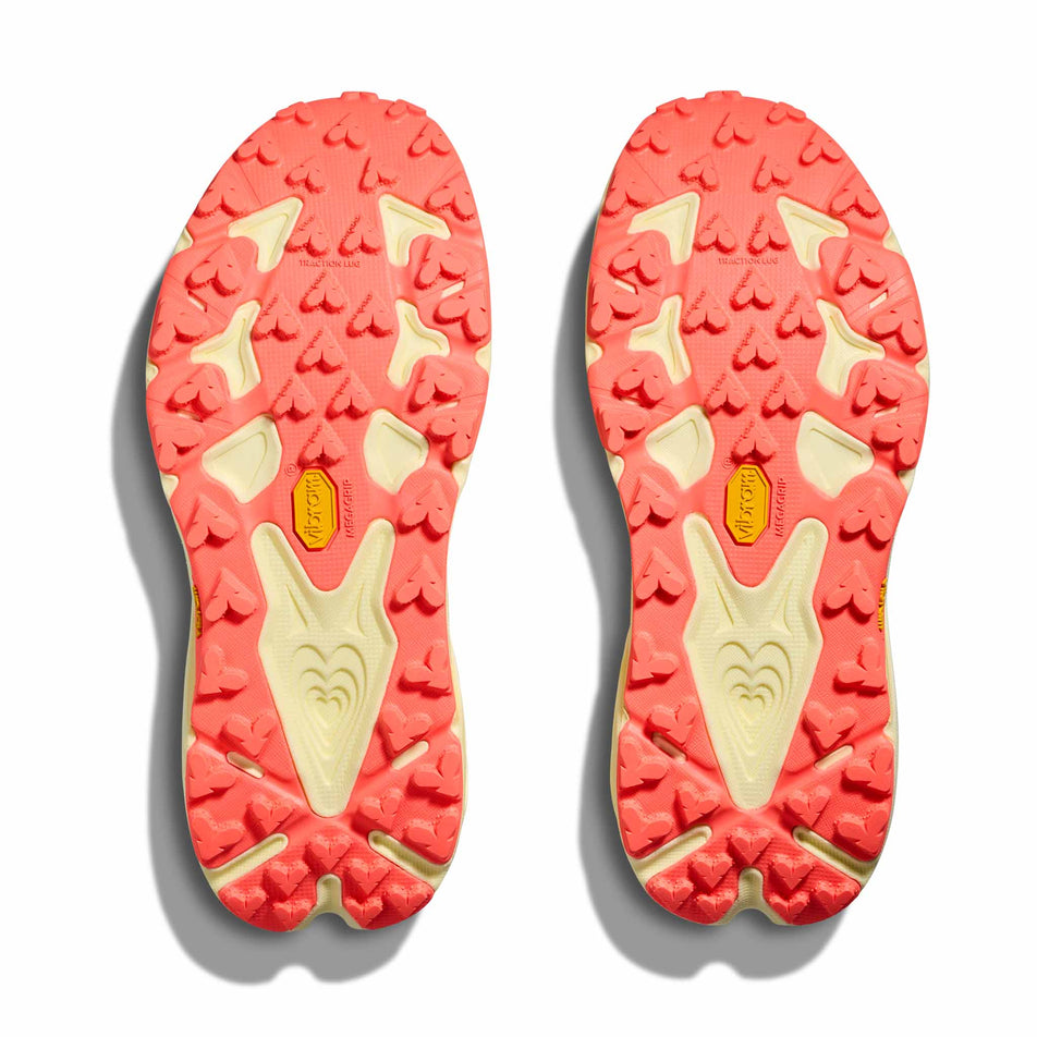 The outsoles of a pair of HOKA Women's Speedgoat 7 Running Shoes in the Vintage Yellow/Neon Flame colourway.