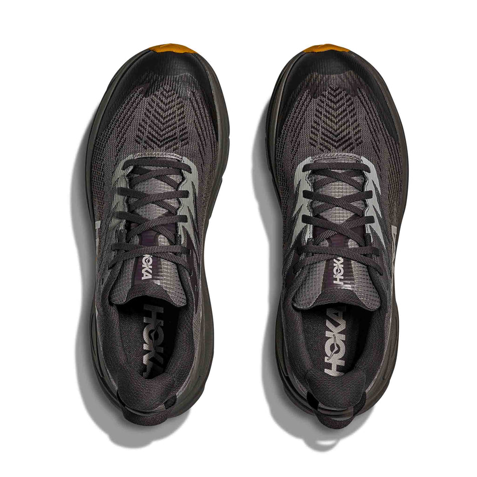 The uppers of a pair of HOKA Men's Challenger 8 GTX Running Shoes in the Asphalt Grey/Varsity Yellow colourway.