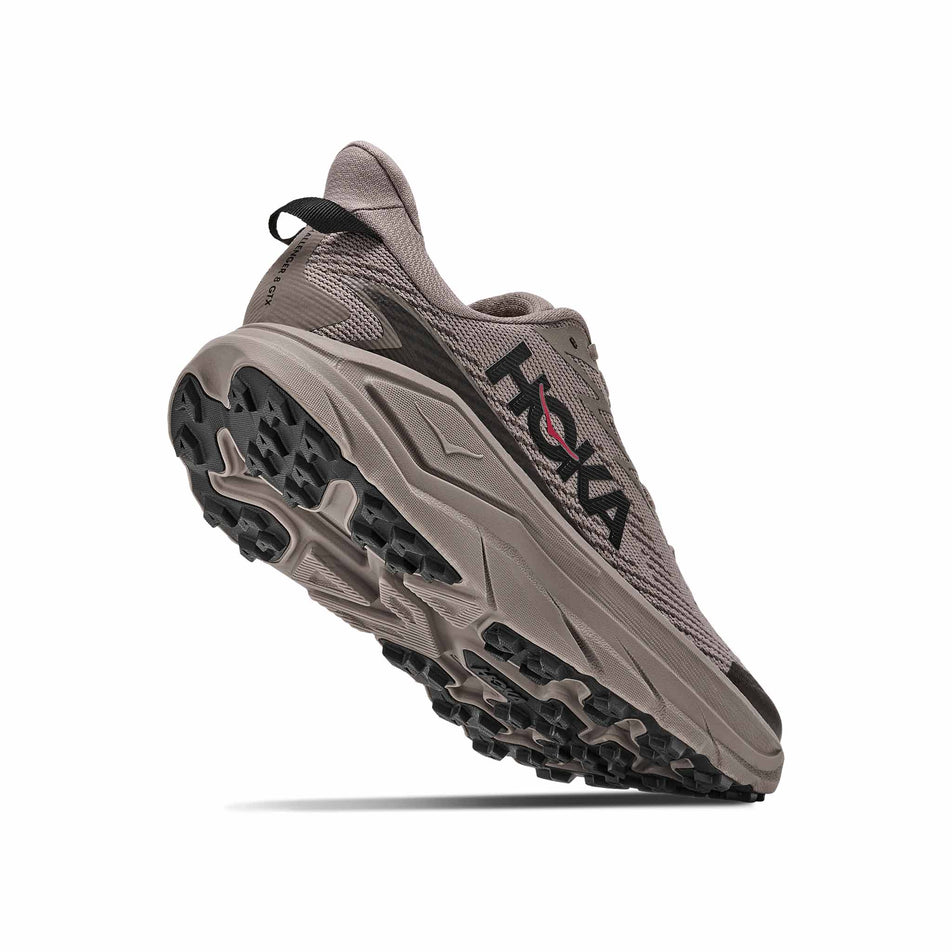Lateral - and outsole - view of the right shoe from a pair of HOKA Men's Challenger 8 GTX Trail Running Shoes in the Pebble Grey/Boulder Grey colourway.