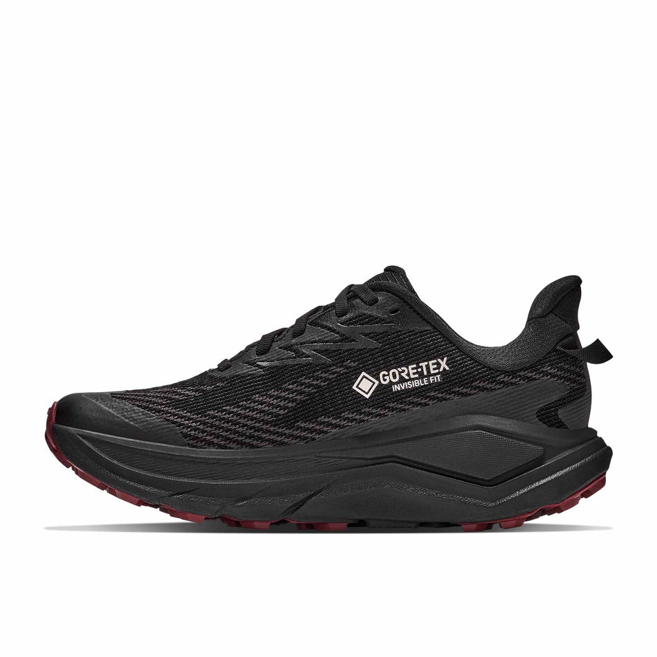 Medial view of the right shoe from a pair of HOKA Women's Challenger 8 GTX Trail Running Shoes in the Black/Varsity Burgundy colourway.