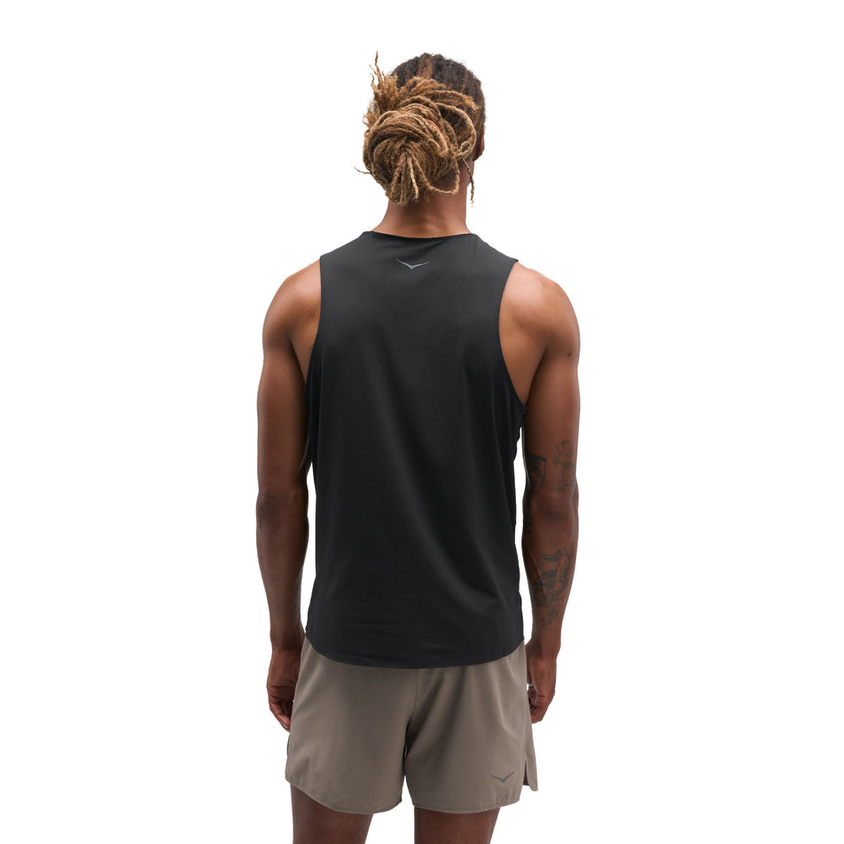 Back view of a model wearing the HOKA Men's Everyrun Tank in the Black colourway.