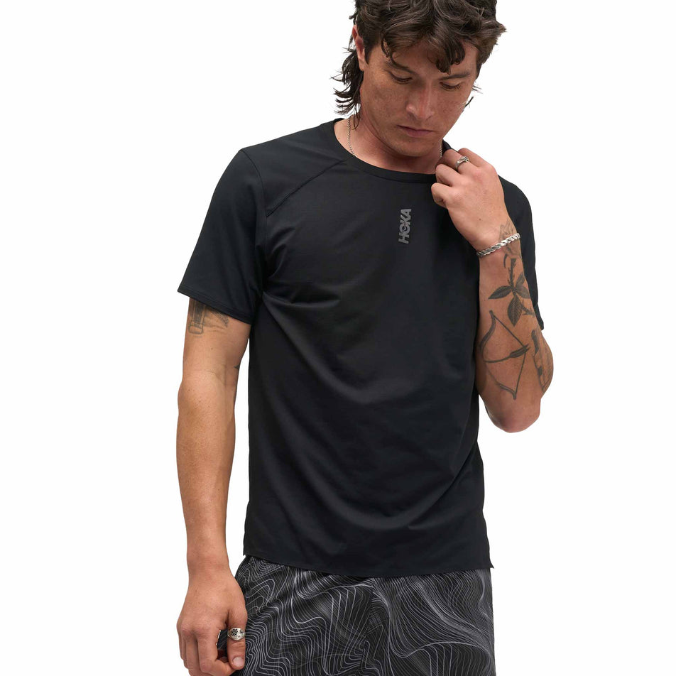 Front view of a model wearing the HOKA Men's Everyrun Short Sleeve in the Black colourway.