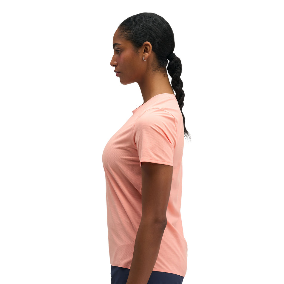 Side view of a model wearing the HOKA Women's Everyrun Short Sleeve in the Sunstone colourway.