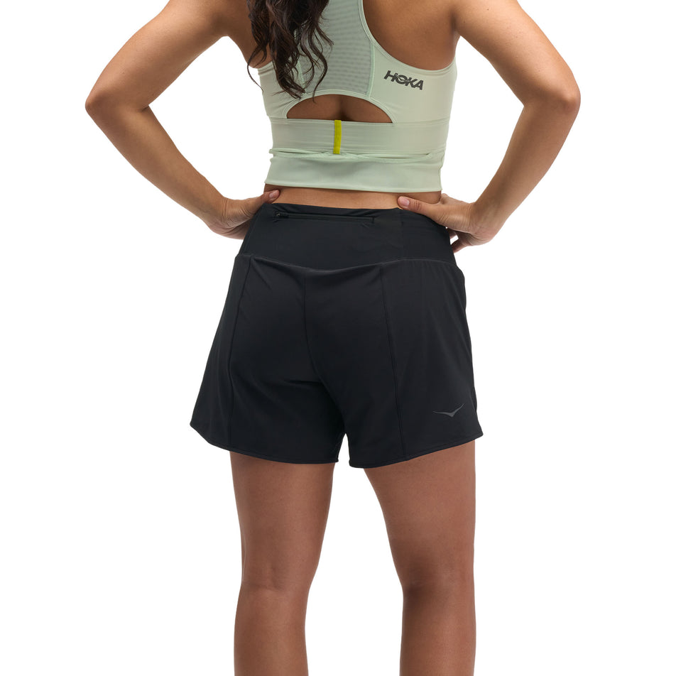 Back view of a model wearing the HOKA Women's Glide Short Mid-Rise 5