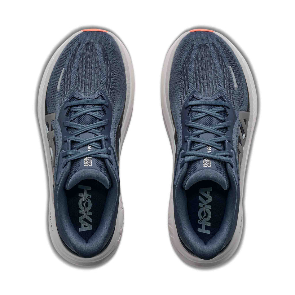 The uppers of a pair of HOKA Women's Clifton Pro Running Shoes in the Faded Navy/Glimmering Blue colourway.