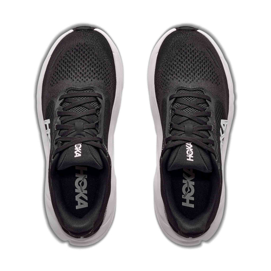The uppers of a pair of HOKA Men's Arahi 9 Wide Running Shoes in the Black/White colourway.