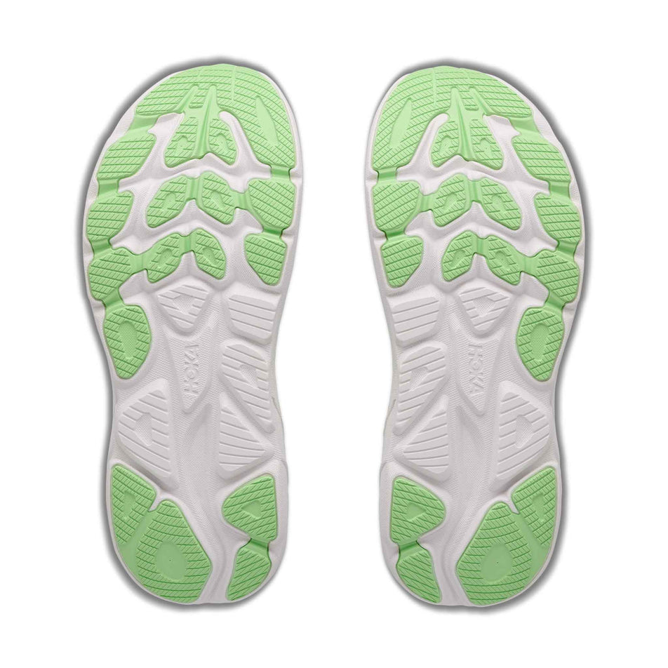 The outsoles of a pair of HOKA Women's Clifton 11 Wide Running Shoes in the Frost/Neon Yuzu colourway.