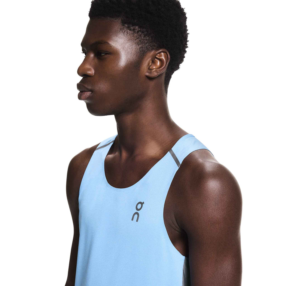 Angled view of a model wearing the On Men's Performance Tank in the Gourami/Rock colourway.