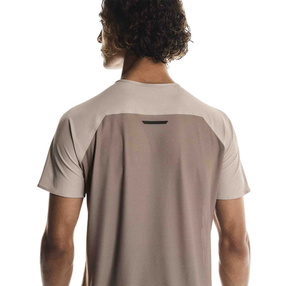 Back view of a model wearing the On Men's Performance-T in the Desert/Cinder colourway.